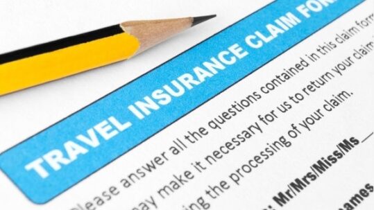 A travel insurance claim form with a pencil