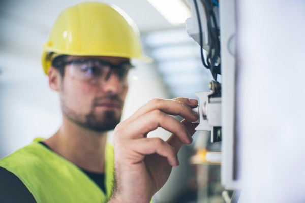 Electrician fixing up the wires and measuring volts